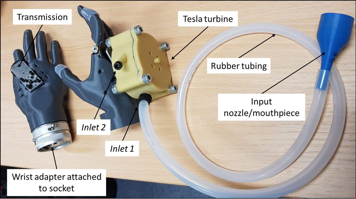 Prosthetic components, including the hand with a wrist adapter to attach to the arm prosthetic, the Tesla turbine, and the rubber tube from the turbine to the input nozzle/mouthpiece.