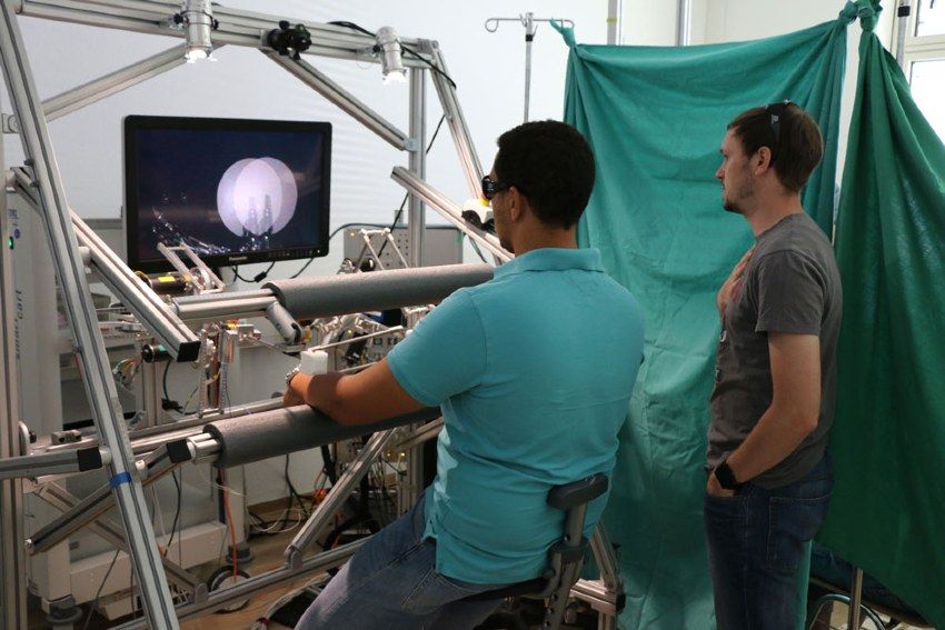 Figure 5. Johannes Bilz and colleague conducting a task performance test to evaluate haptic feedback and 3D endoscope vision at University Hospital Tübingen.